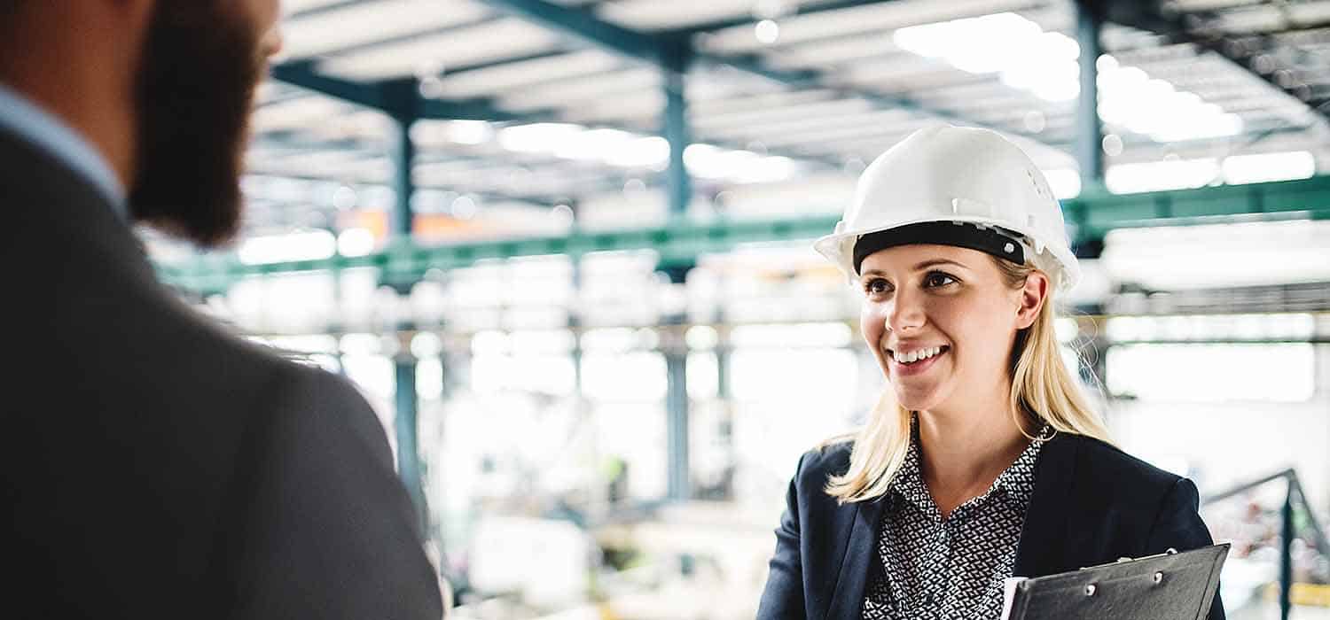 female health and safety consultant meeting factory senior director on site visit